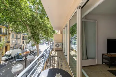 an apartment balcony with a view of a street at 29 CARNOT - Chaleureux appartement avec balcon - centre ville in Cannes