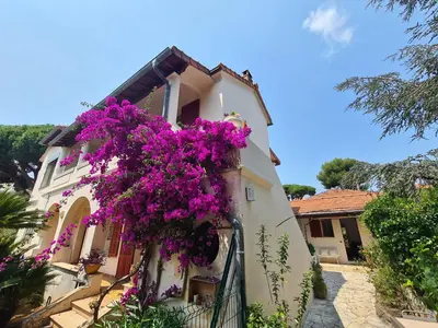 a building with purple flowers on the side of it at PROCHE CONGRES PLAGES CLIM in Cannes