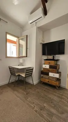 a room with a desk and a television and a chair at PROCHE CONGRES PLAGES CLIM in Cannes