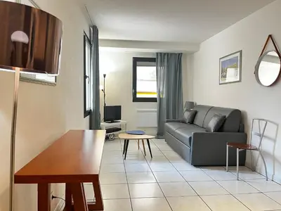 a living room with a couch and a table at Cannes en plein cœur in Cannes