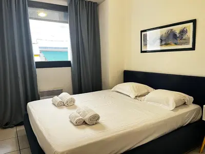 a bedroom with a bed with towels on it at Cannes en plein cœur in Cannes