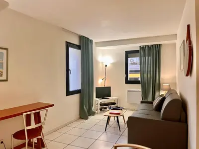 a living room with a couch and a table at Cannes en plein cœur in Cannes