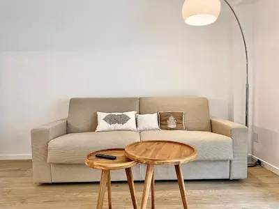 a living room with a couch and a table at Appartement Cannes 2 chambres - 14J in Cannes