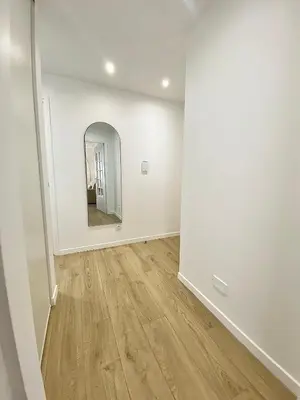 an empty room with a mirror and wooden floors at Appartement Cannes 2 chambres - 14J in Cannes