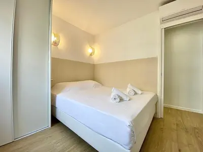 a small room with a bed with towels on it at Appartement Cannes 2 chambres - 14J in Cannes