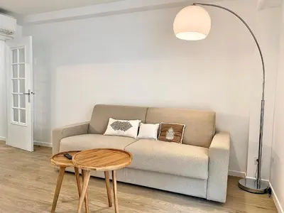 a living room with a couch and a table at Appartement Cannes 2 chambres - 14J in Cannes