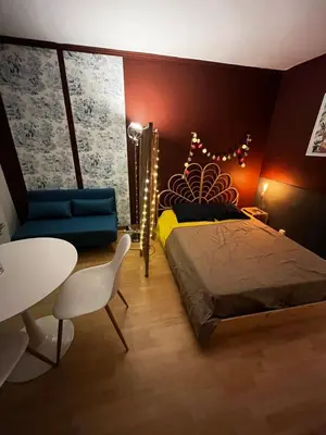 a bedroom with a bed and a table and a chair at Cosy Studio - Plage et Suquet in Cannes