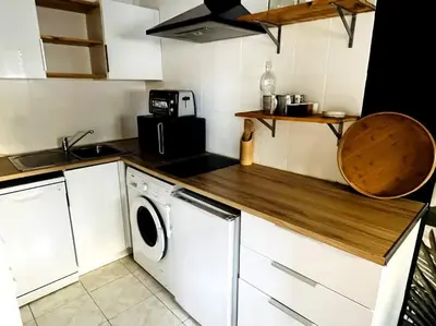 a kitchen with a washer and a washing machine at Cosy Studio - Plage et Suquet in Cannes