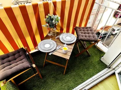 a balcony with a table and chairs on a balcony at Cosy Studio - Plage et Suquet in Cannes