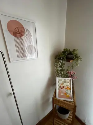 a table with a picture and a plant on a wall at Cosy Studio - Plage et Suquet in Cannes