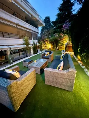a patio with couches and tables on the grass at Luxus Wohnung nahe Croisette in Cannes