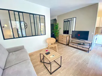 a living room with a couch and a tv at La Bergerie By SCLS Locations in Cannes