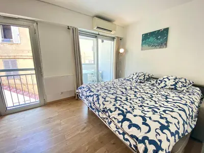 a bedroom with a bed and a large window at La Bergerie By SCLS Locations in Cannes