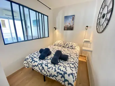 a bedroom with a bed with two pillows on it at La Bergerie By SCLS Locations in Cannes