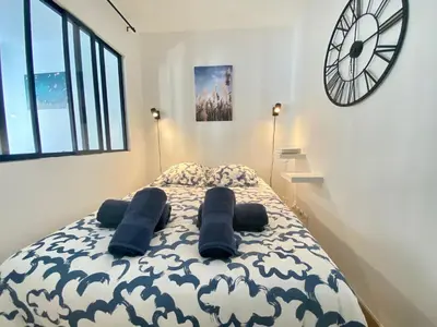 a bedroom with a bed with two pillows on it at La Bergerie By SCLS Locations in Cannes
