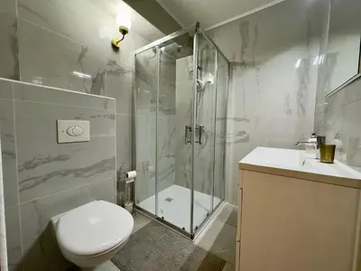 a bathroom with a shower and a toilet and a sink at La Bergerie By SCLS Locations in Cannes