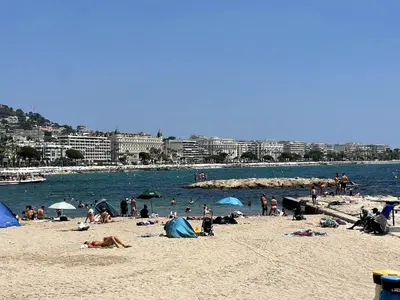 a group of people on a beach near the water at Beach Studio Cannes in Cannes