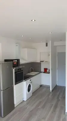 a kitchen with a washing machine and a washer at Beach Studio Cannes in Cannes