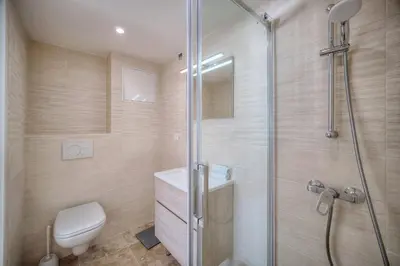 a bathroom with a shower with a toilet and a sink at REF 1174 - Apartment with Sea View in Cannes