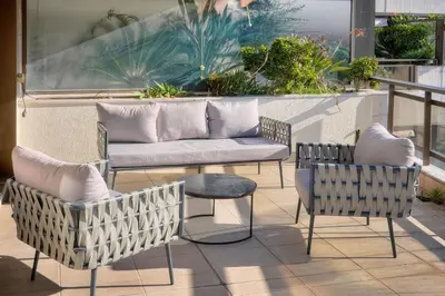 a patio with two chairs and a couch on a balcony at REF 1174 - Apartment with Sea View in Cannes