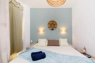 a bedroom with a bed and a clock on the wall at Centre studio plage et festival in Cannes