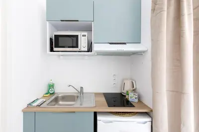 a kitchen with a sink and a microwave at Centre studio plage et festival in Cannes