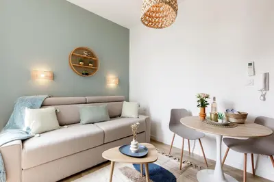 a living room with a couch and a table at Centre studio plage et festival in Cannes