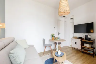 a living room with a couch and a table at Centre studio plage et festival in Cannes