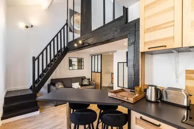 a kitchen and living room with a table and chairs at 3 LEGOF - Charmant appartement 4 couchages centre Cannes in Cannes