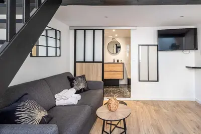 a living room with a couch and a table at 3 LEGOF - Charmant appartement 4 couchages centre Cannes in Cannes