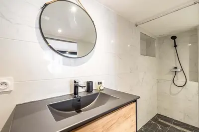 a bathroom with a sink and a mirror at 3 LEGOF - Charmant appartement 4 couchages centre Cannes in Cannes
