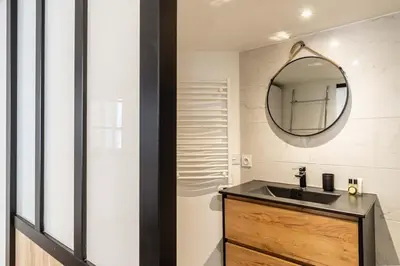 a bathroom with a sink and a mirror at 3 LEGOF - Charmant appartement 4 couchages centre Cannes in Cannes