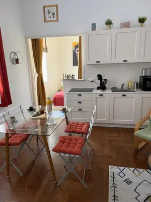 a kitchen with a glass table and chairs in a room at HENRI CAMILLE REAL ESTATE - Florida 2 - 2 bedrooms close center in Cannes