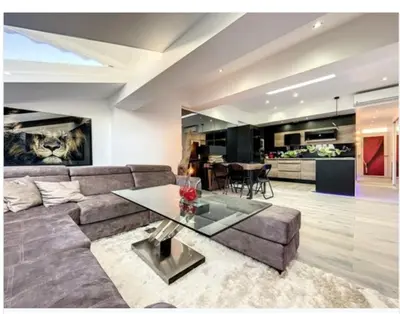 a living room with a couch and a table at Appartement Palais des Festivals in Cannes