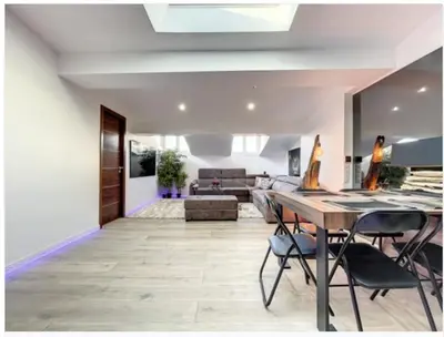 a living room with a table and chairs and a couch at Appartement Palais des Festivals in Cannes