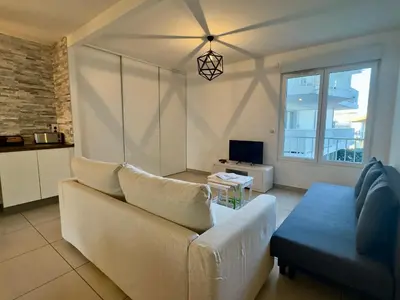 a living room with a couch and a table at Cannes Maria By SCLS Locations in Cannes