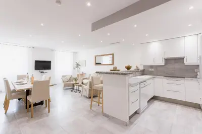 a kitchen and dining room with a table and chairs at 38 Meynadier 4p by Halldis in Cannes