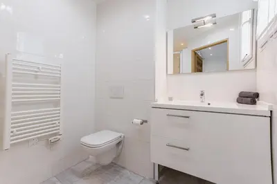 a white bathroom with a toilet and a sink at 38 Meynadier 4p by Halldis in Cannes
