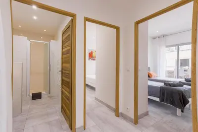 a bedroom with a bed and a bathroom with a mirror at 38 Meynadier 4p by Halldis in Cannes