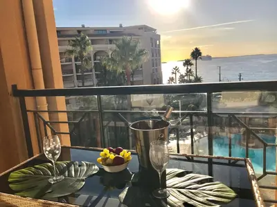 a table with a bowl of fruit on top of a balcony at Appartement 531 in Cannes
