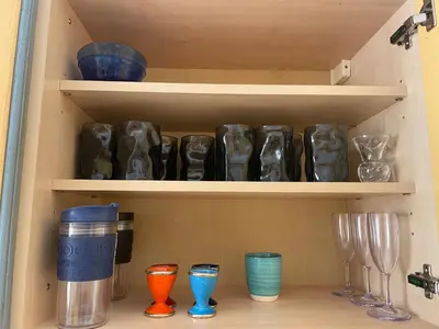 a cupboard filled with lots of different colored glassases at Toit terrasse proche plages Croisette et Palais des Festivals in Cannes