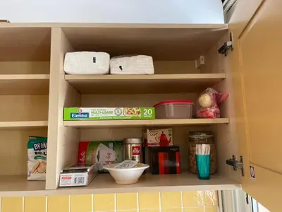 a kitchen pantry with food items on a shelf at Toit terrasse proche plages Croisette et Palais des Festivals in Cannes