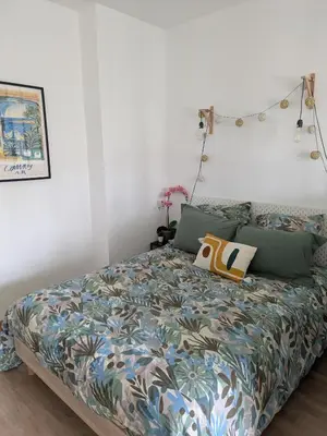 a bedroom with a bed with a colorful comforter at Cannes Isola Bella entre mer et montagne in Cannes
