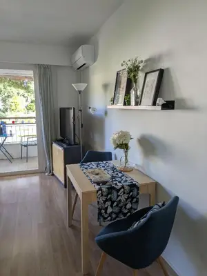 a living room with a table and two chairs at Cannes Isola Bella entre mer et montagne in Cannes