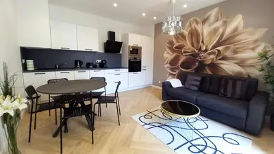 a living room with a blue couch and a table at Lovely apartment heart of Cannes in Cannes