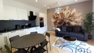 a kitchen and dining room with a table and a couch at Lovely apartment heart of Cannes in Cannes