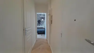 a hallway with a white door leading to a bedroom at Lovely apartment heart of Cannes in Cannes
