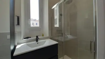 a bathroom with a sink and a glass shower at Lovely apartment heart of Cannes in Cannes