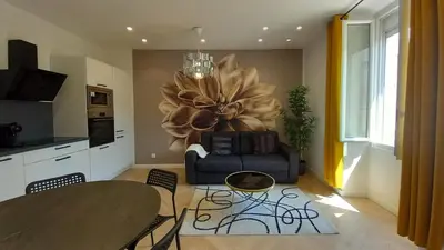 a living room with a table and a couch at Lovely apartment heart of Cannes in Cannes