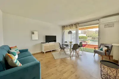a living room with a blue couch and a table at Bright studio just outside Cannes in Le Cannet